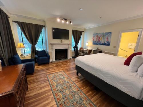 a bedroom with a bed and a living room at Old Brick Inn in Saint Michaels