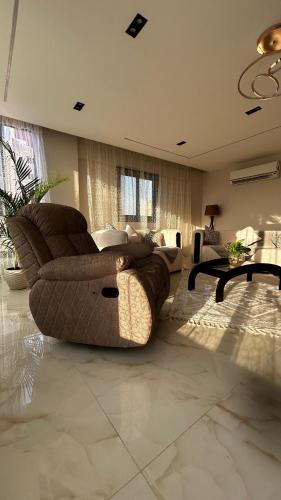 a living room with a couch and a table at Avenu Al-3rab Hotel in Cairo