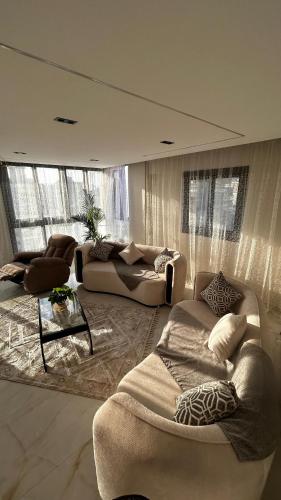a large living room with two couches and a table at Avenu Al-3rab Hotel in Cairo