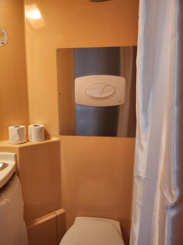 a bathroom with a toilet and a sink at Premiere Classe Roissy CDG - Paris Nord 2 - Parc des Expositions in Roissy-en-France
