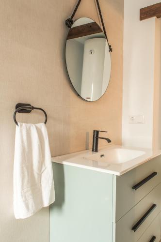a bathroom with a white sink and a mirror at Casa de Mamachon in Cazorla