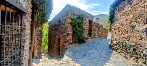 a painting of an alleyway between two stone buildings at El Mirador de Las Jaras in Patones