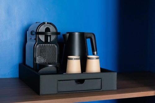 a black box with a blender and cups on a table at Hotel Plaza Biarritz Plage - Handwritten Collection in Biarritz