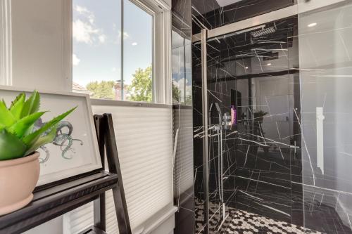 a glass shower in a bathroom with a plant at Port Clinton Home with Lake View - Walk to Beach! in Port Clinton
