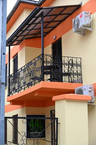 an apartment building with a balcony and an air conditioner at Station 44 Apartments in Bitola