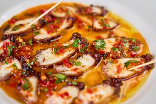 a white bowl of food with meat and sauce at Silver Sands Motel & Beach Bungalows in Greenport