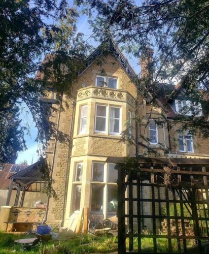 an old brick house with a fence in front of it at 3 bedroom 3 bathroom ground floor condo with veranda in Reigate