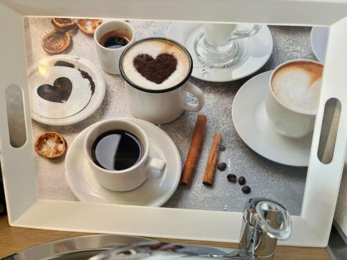 a picture of cups of coffee and plates of food at Auszeit am Rhein 1 - Rhinelove in Boppard