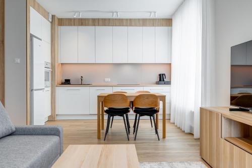 a kitchen with a table and two chairs in a room at King Apartamenty Galaxy in Szczecin