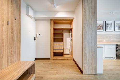 a room with white walls and wooden floors at King Apartamenty Galaxy in Szczecin
