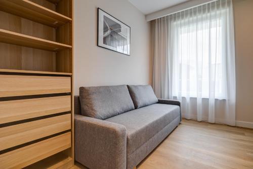 a living room with a couch and a window at King Apartamenty Galaxy in Szczecin