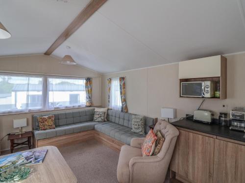 a living room with a couch and a table at Tri-Star House in Charmouth