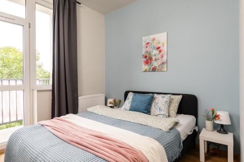 a bedroom with a bed and a window at SuperApart Zdobnicza 4 in Warsaw