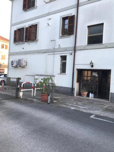 a white building with windows and plants in front of it at MELA's HOUSE B in Colleferro