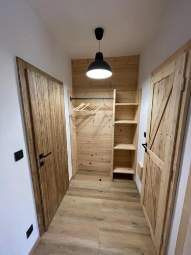 a hallway with a door and stairs in a room at Inovecká Chata in Trenčianske Jastrabie