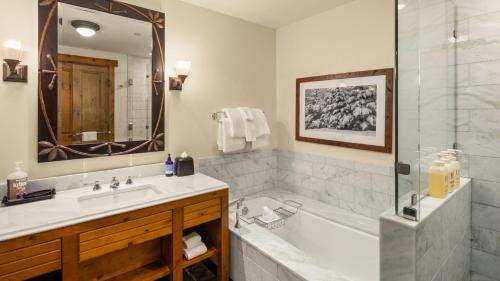 a bathroom with a tub and a sink at 309 VILLAGE GREEN By Stowe Mountain Rentals in Stowe