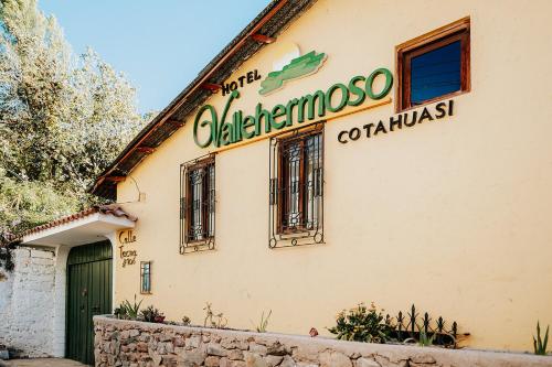 a building with a sign on the side of it at Hotel Vallehermoso in Cotahuasi