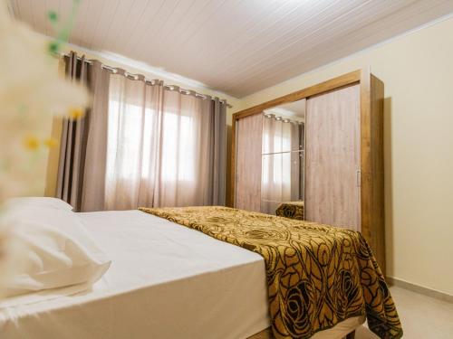 Ένα ή περισσότερα κρεβάτια σε δωμάτιο στο Casa para até 10 pessoas com churrasqueira QF1846