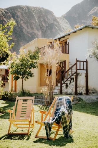 a person sitting on a chair in a yard at Hotel Vallehermoso in Cotahuasi