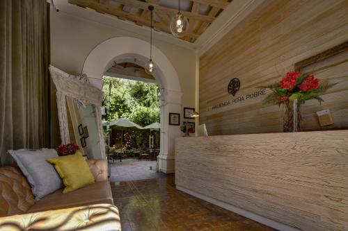 a living room with a couch and a large window at Hacienda Peña Pobre in Mexico City