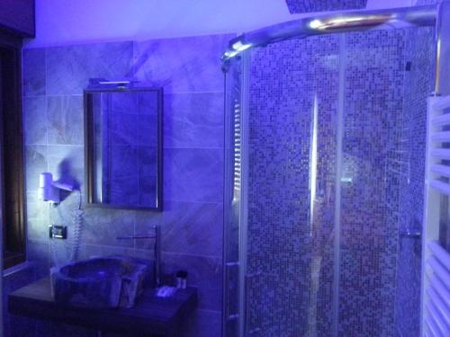 a bathroom with a shower and a sink at Hotel al Sole in Auronzo di Cadore