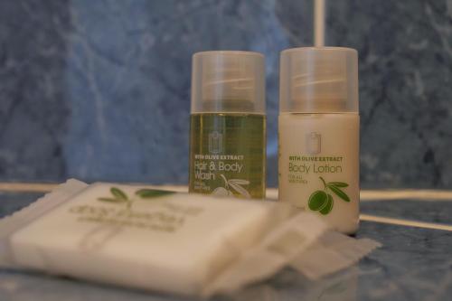 two bottles oficatedicatedicatedicatedicatedicated soap and a box oficatingicated at Les chambres de l'Elysée in Pontrieux