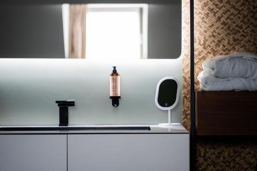 a bathroom with a sink and a mirror at L'Olivier in Mons