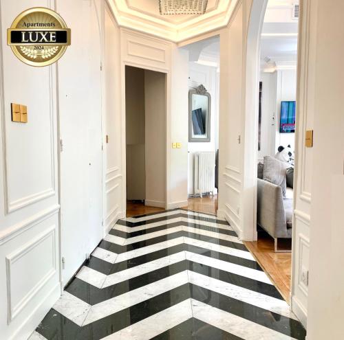 a hallway with a black and white checkered floor at New! Apartment Luxury Passy-Kennedy in front of Eiffel Tower in Paris