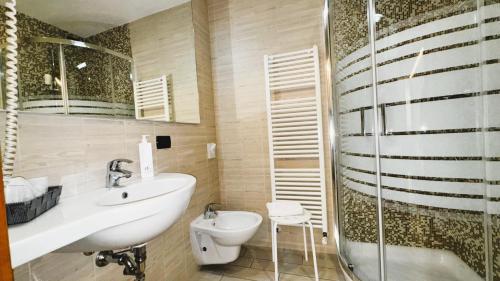 a bathroom with a sink and a toilet and a shower at Hotel Fontana Verona in Verona