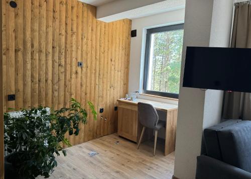 a room with a desk and a window and a monitor at Vila Aspen - Mountain View Apartments in Delčevo