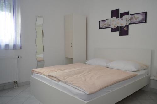 Postel nebo postele na pokoji v ubytování Permarinus Apartments