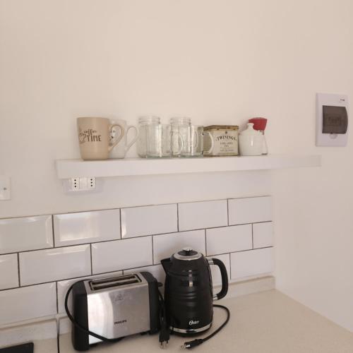 a kitchen counter with a toaster and a toaster and cups at Casa AltaVista Guanaqueros in Guanaqueros
