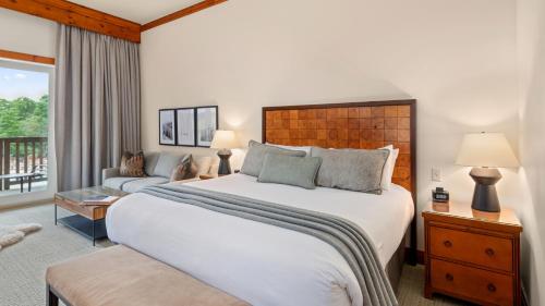a bedroom with a large bed and a couch at 343 Studio NATIONAL 3rd Floor Pool & Mountain Views By Stowe Mountain Rentals in Stowe