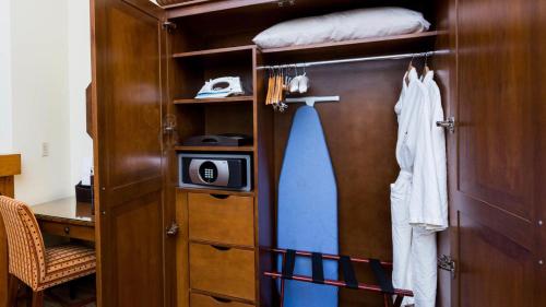 a room with a closet with a door and a microwave at 343 Studio NATIONAL 3rd Floor Pool & Mountain Views By Stowe Mountain Rentals in Stowe