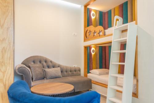 a living room with a couch and a bunk bed at Luna Mare Boutique Seaside in Borsh