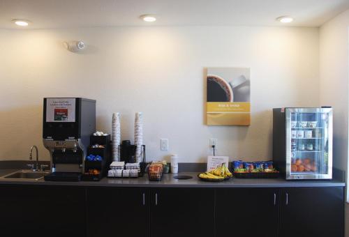 a counter top with a coffee maker and a refrigerator at Motel 6-Mankato, MN in Mankato