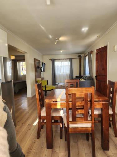 a dining room and living room with a table and chairs at Apartamento La Calera in La Calera