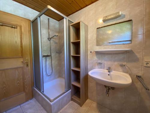 a bathroom with a shower and a sink and a shower at Obenfigerhof in Kals am Großglockner