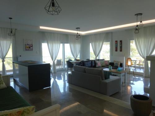 a living room with a couch and a table at Palio Seaside Escape in Kavala