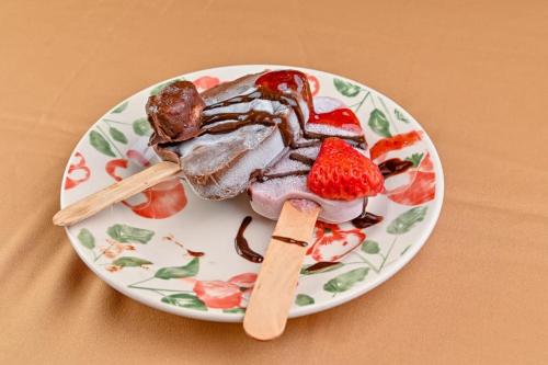 a plate of food with strawberries on a table at Lands in Love Hotel and Resort in Colonia Palmareña