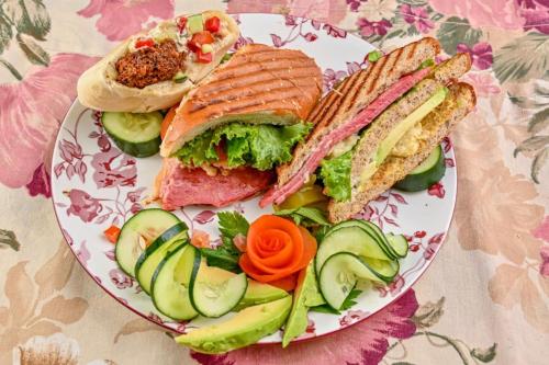 a plate of sandwiches and vegetables on a table at Lands in Love Hotel and Resort in Colonia Palmareña
