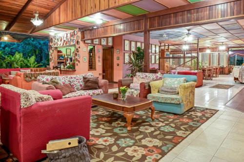a living room with many couches and a table at Lands in Love Hotel and Resort in Colonia Palmareña