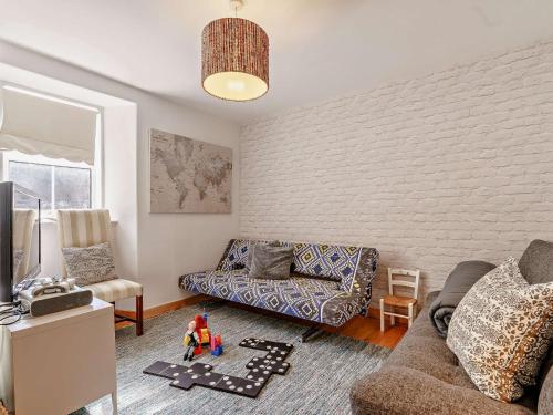 a living room with a couch and a chair at InEdra Estate Farmhouse by edradour1725 in Pitlochry