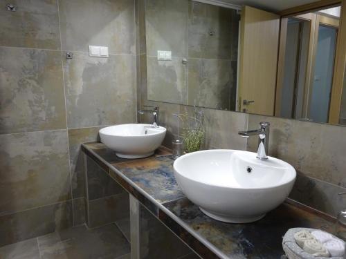 a bathroom with two sinks and a mirror at Palio Seaside Escape in Kavala