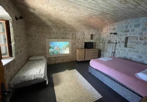Postel nebo postele na pokoji v ubytování Stone Apartment Risan