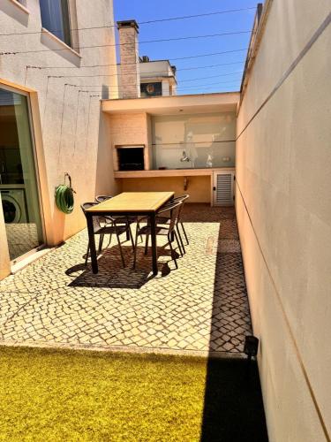a patio with a table and chairs on a sidewalk at Alfarim House - close to Meco beach and Sesimbra in Sesimbra