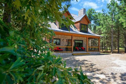 a large house with a gambrel roof on top at The Whiskey Trip! Family Getaway in Broken Bow