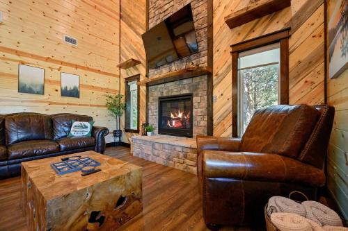 a living room with leather furniture and a fireplace at The Whiskey Trip! Family Getaway in Broken Bow