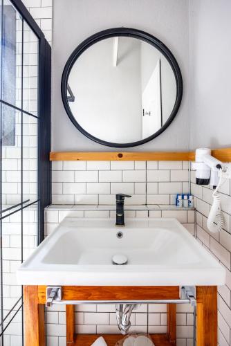 a bathroom with a sink and a mirror at Akkum Beach Otel in Seferihisar
