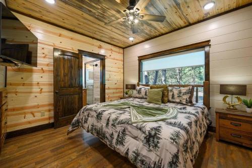 a bedroom with a bed and a ceiling fan at The Whiskey Trip! Family Getaway in Broken Bow
